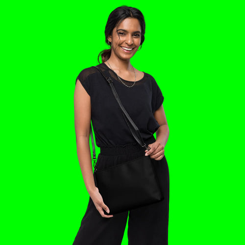 Blessed & Grateful® black faux-leather crossbody bag with white logo print, adjustable strap — back view