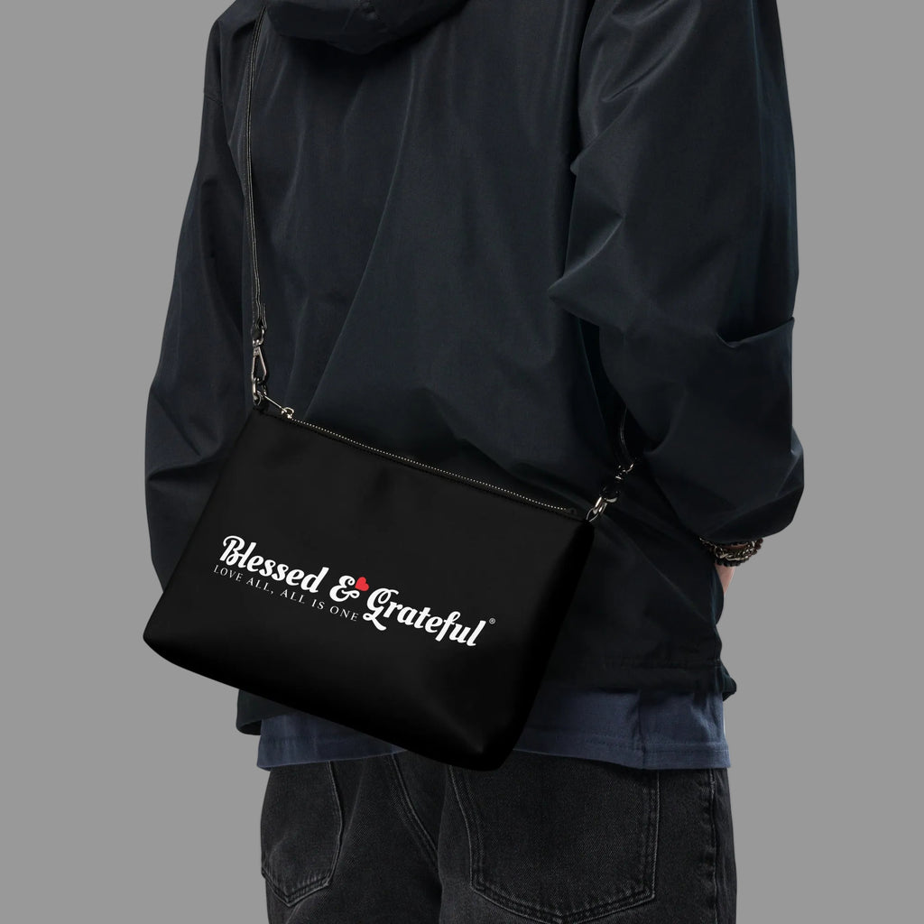 Blessed & Grateful® black faux-leather crossbody bag with white logo print, adjustable strap — front view