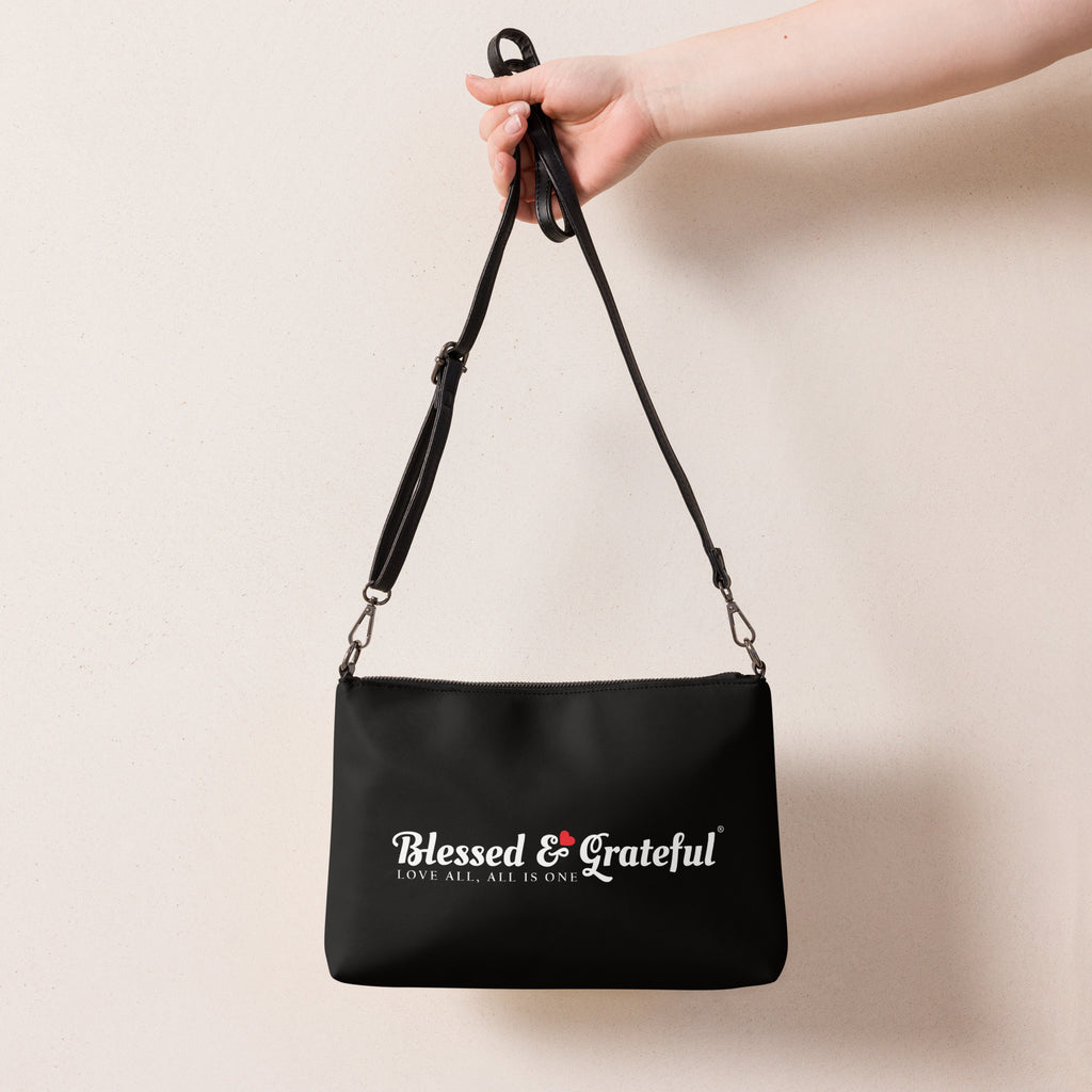 Blessed & Grateful® black faux-leather crossbody bag with white logo print, adjustable strap — front view