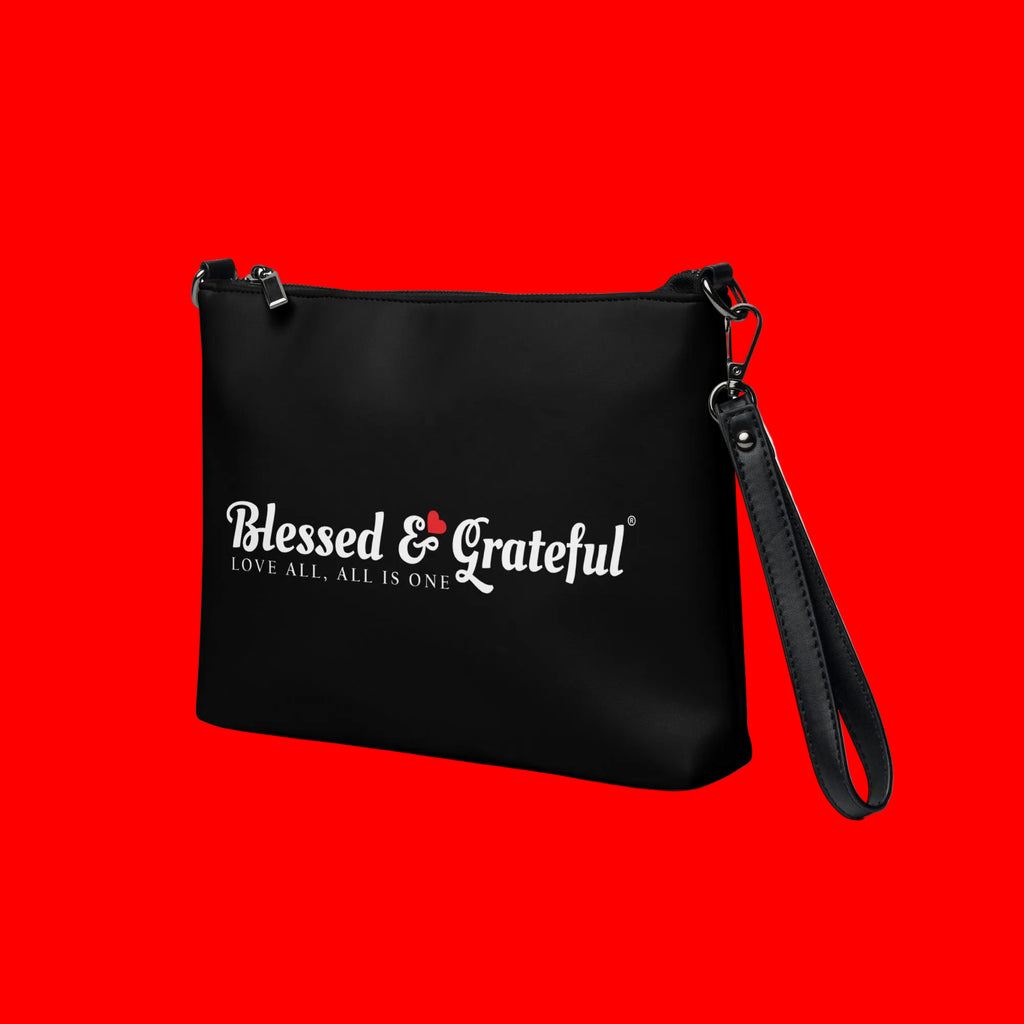 Blessed & Grateful® black faux-leather crossbody bag with white logo print, adjustable strap — left side view